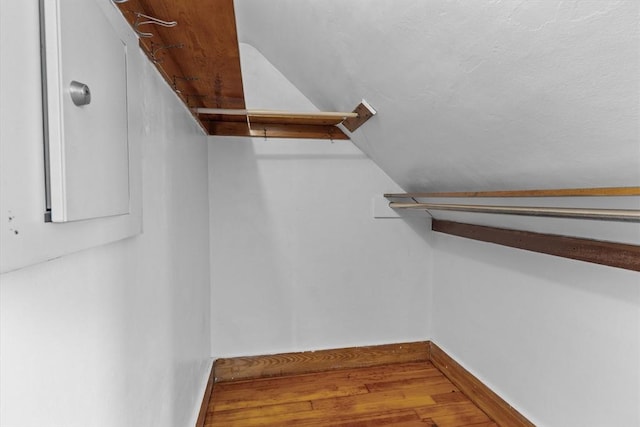 spacious closet featuring vaulted ceiling and wood finished floors