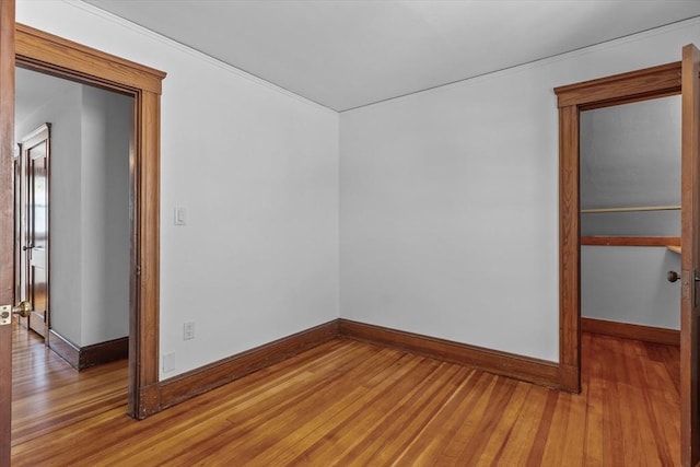 empty room with baseboards and light wood finished floors