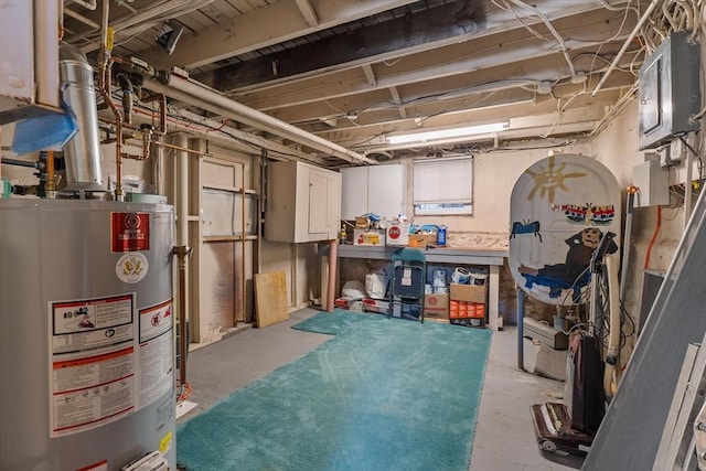 unfinished below grade area with water heater and a workshop area