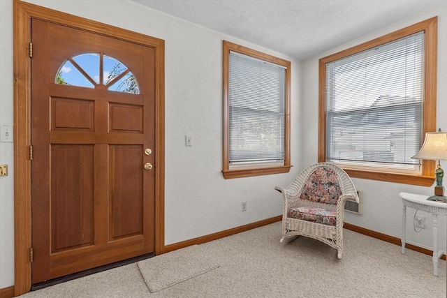 carpeted entrance foyer with baseboards