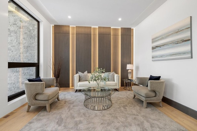 sitting room with recessed lighting, visible vents, light wood-style flooring, and baseboards