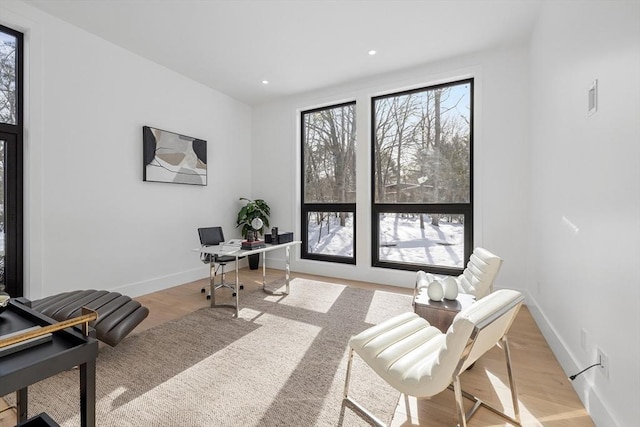 office featuring light wood-style floors, visible vents, baseboards, and recessed lighting