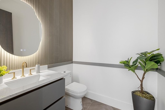 half bathroom featuring toilet, tile patterned flooring, and vanity