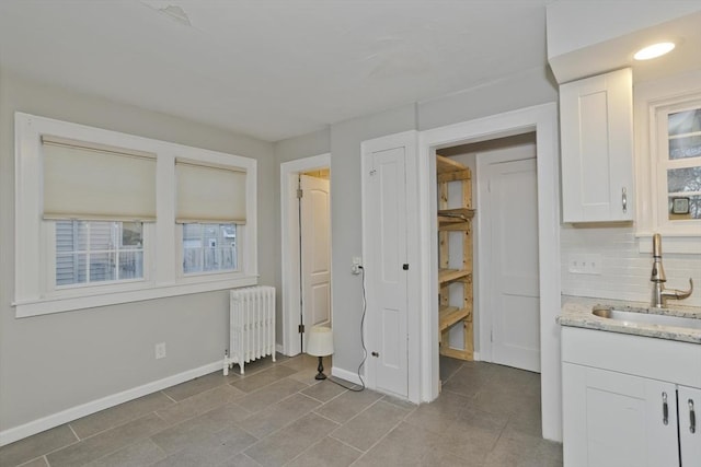 interior space featuring radiator heating unit and a sink