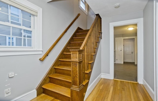 staircase with baseboards and hardwood / wood-style floors