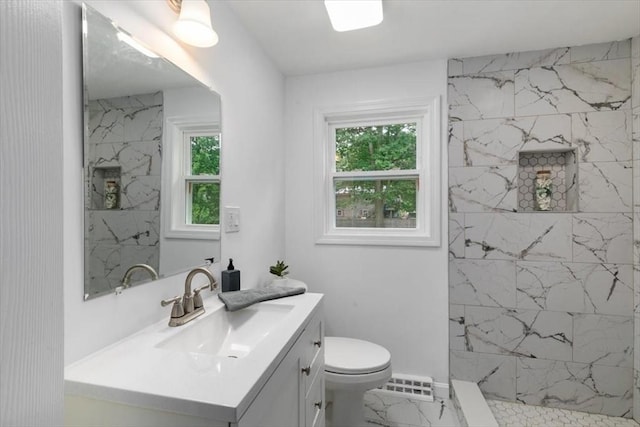 691 Beacon St, Lowell, MA 01850 - full bath featuring marble finish floors, vanity, healthy amount of natural light, and a marble finish shower