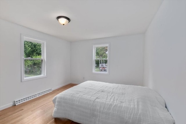 691 Beacon St, Lowell, MA 01850 - bedroom featuring baseboard heating and light wood-style floors