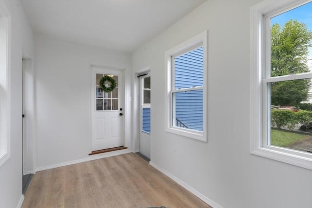 691 Beacon St, Lowell, MA 01850 - doorway to outside featuring light wood-type flooring and baseboards