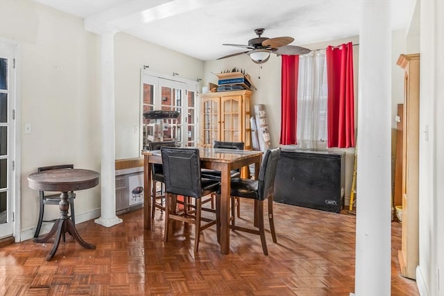 dining room featuring ornate columns, baseboards, a ceiling fan, and french doors