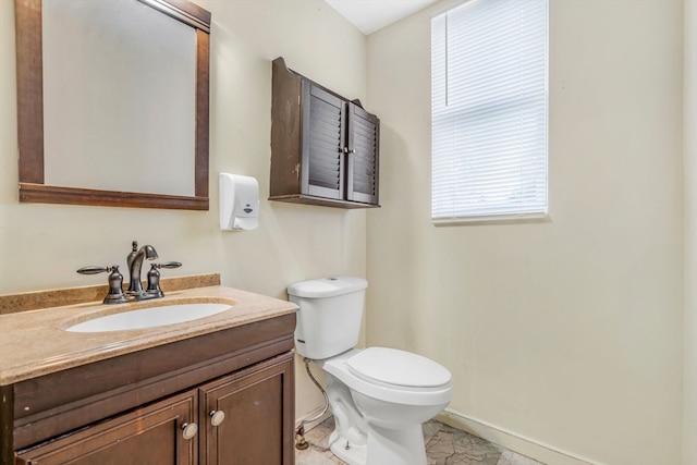 bathroom featuring vanity, toilet, and tile patterned flooring