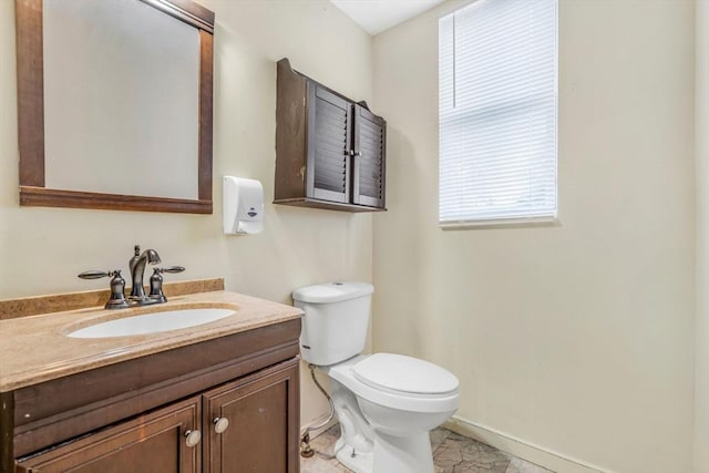 bathroom featuring marble finish floor, vanity, toilet, and baseboards