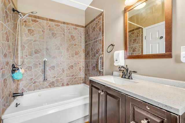 bathroom featuring tiled shower / bath combo and vanity