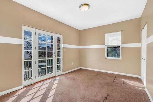 unfurnished room with carpet and baseboards