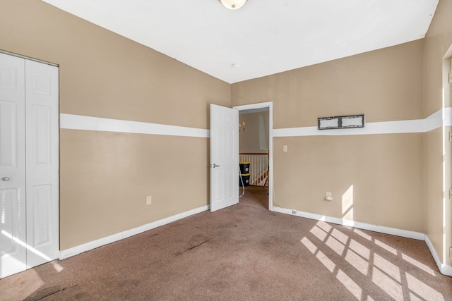 unfurnished bedroom with a closet and carpet floors