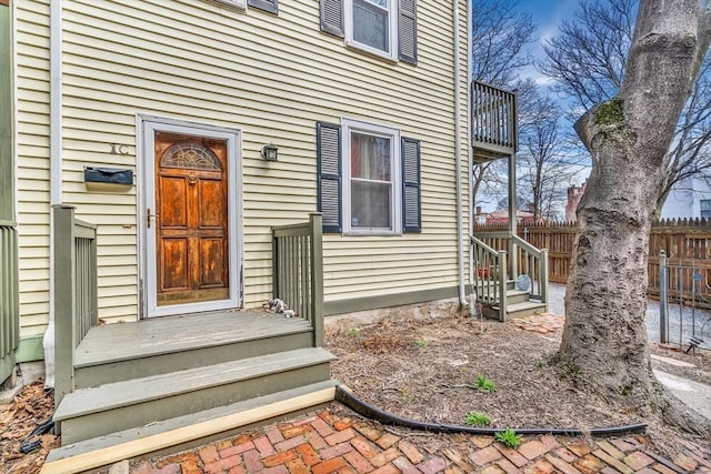 view of exterior entry with fence