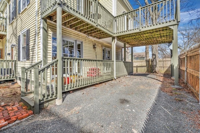 view of patio featuring fence private yard and a wooden deck