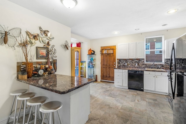 kitchen with white cabinets, sink, backsplash, light tile patterned flooring, and dishwasher