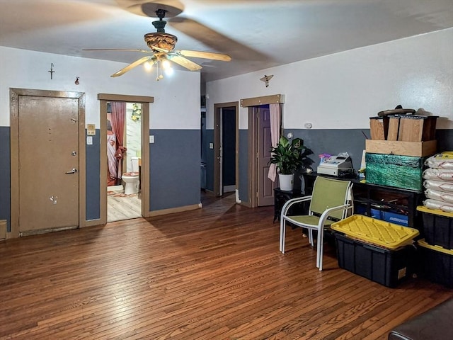 sitting room featuring wood finished floors and a ceiling fan