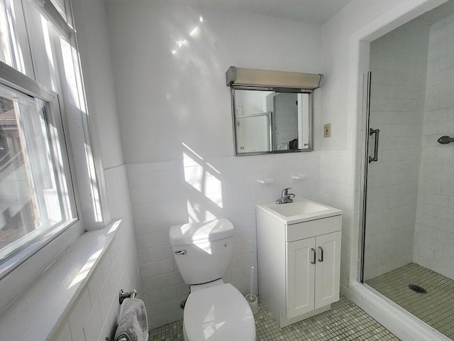 full bathroom featuring toilet, tile walls, a shower stall, and tile patterned flooring