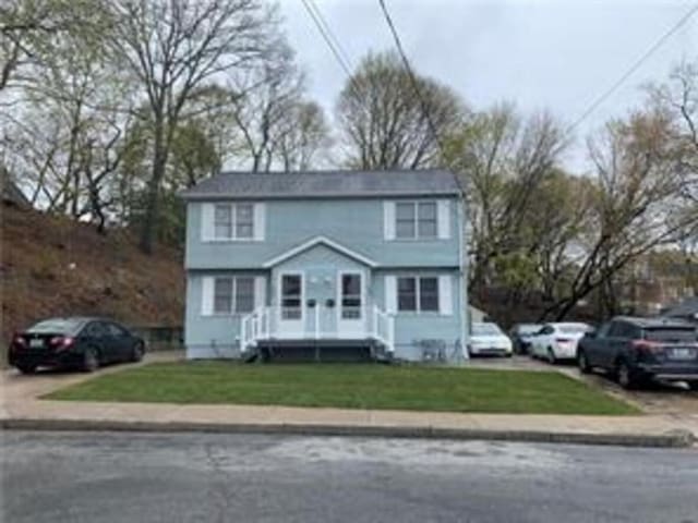 colonial-style house with a front yard