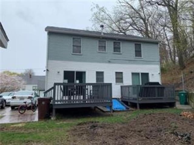 rear view of property featuring a wooden deck