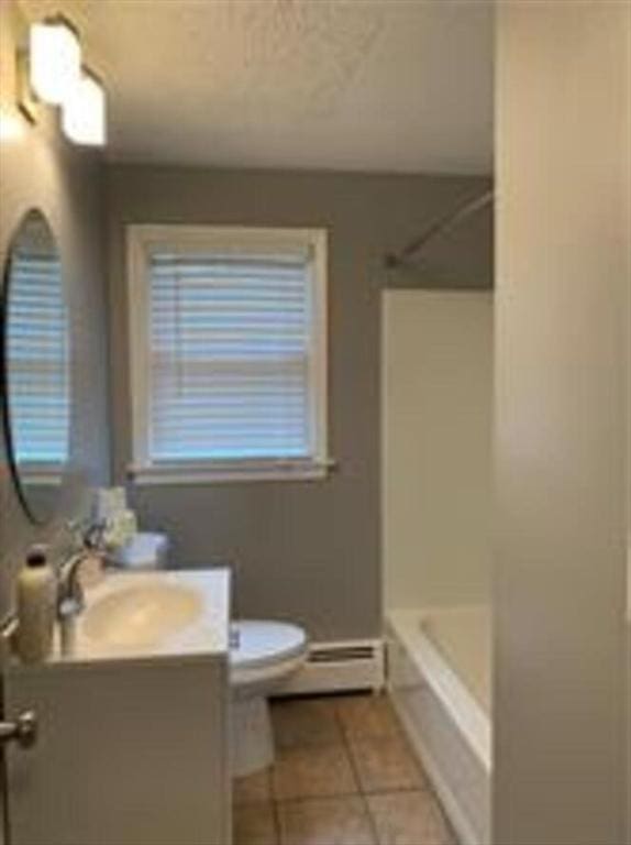 bathroom with vanity, tile patterned floors, toilet, a baseboard heating unit, and shower / tub combination
