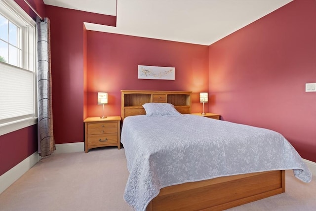carpeted bedroom with baseboards