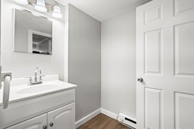 48-50 Portland St, Haverhill, MA 01830 - bathroom with a baseboard heating unit, vanity, and wood finished floors