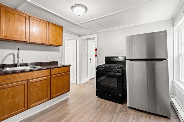 48-50 Portland St, Haverhill, MA 01830 - kitchen with freestanding refrigerator, black gas range oven, baseboard heating, brown cabinets, and light wood finished floors