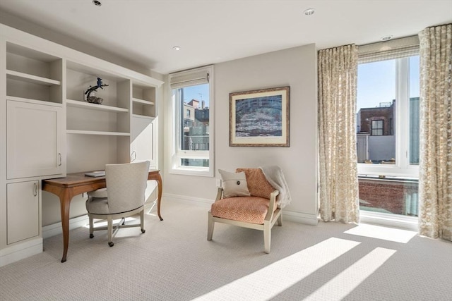 office space featuring light colored carpet and baseboards