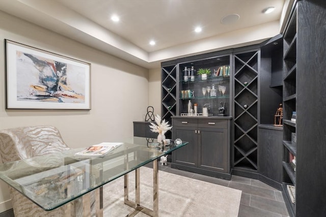 tiled office featuring indoor bar and recessed lighting