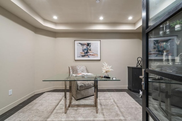 office space with a tray ceiling, baseboards, and recessed lighting