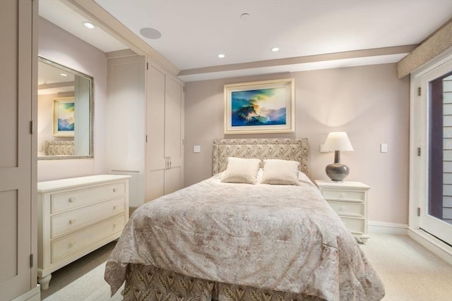 carpeted bedroom featuring baseboards and recessed lighting