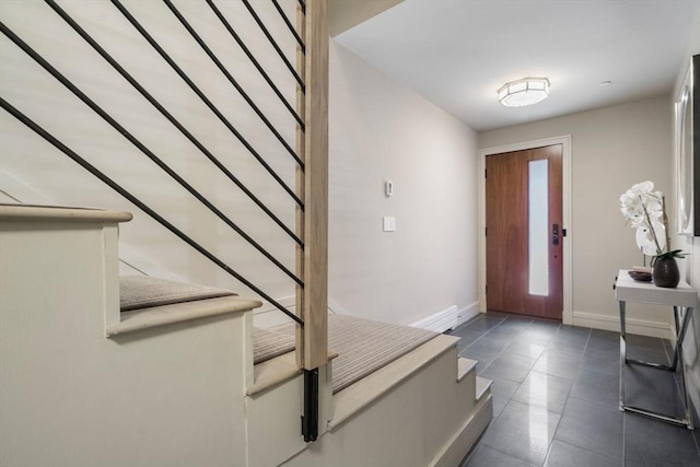 foyer with stairway and baseboards
