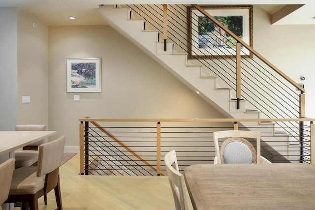 stairway featuring baseboards, recessed lighting, and wood finished floors
