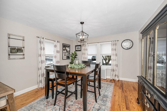 dining space featuring an inviting chandelier and light hardwood / wood-style flooring