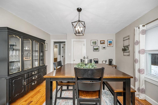 dining area featuring an inviting chandelier and light wood-type flooring