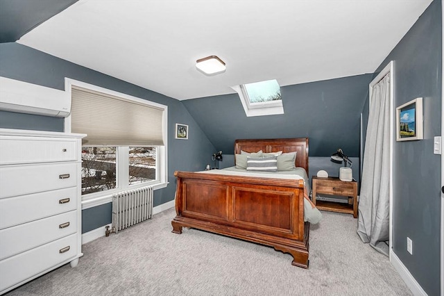 bedroom featuring light carpet, radiator, a wall unit AC, and vaulted ceiling with skylight