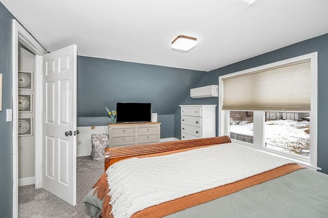 carpeted bedroom with a wall mounted AC and vaulted ceiling