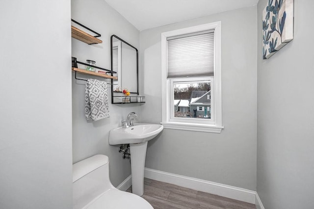 bathroom featuring hardwood / wood-style flooring and toilet