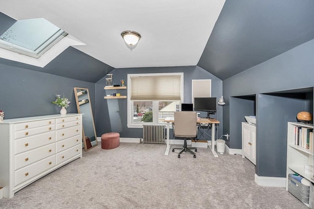 office space featuring radiator, lofted ceiling with skylight, and light colored carpet