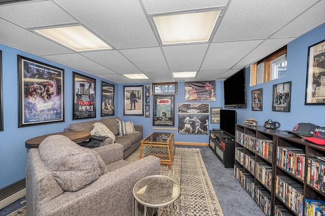 interior space featuring a drop ceiling, a baseboard radiator, and carpet flooring