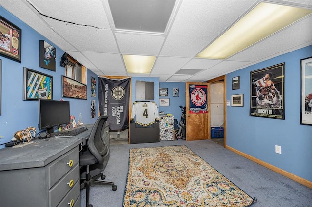 carpeted home office featuring a drop ceiling