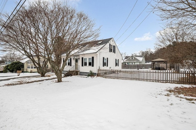 snow covered house featuring a gazebo