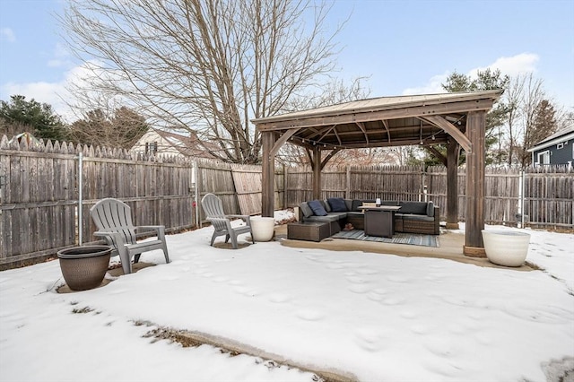 snow covered patio featuring a gazebo and an outdoor living space with a fire pit