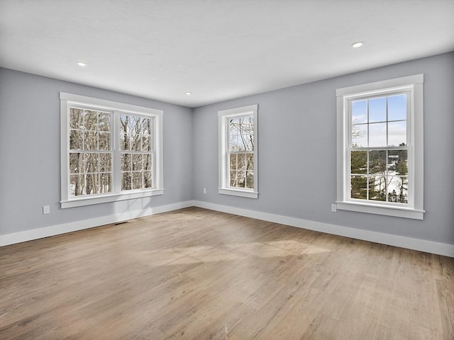 spare room featuring light hardwood / wood-style floors