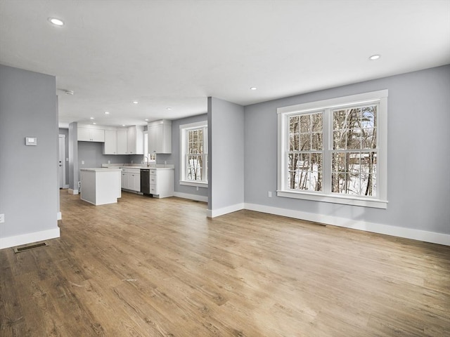 unfurnished living room featuring light hardwood / wood-style floors