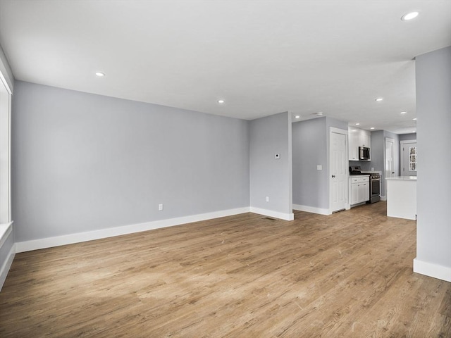 unfurnished living room with light hardwood / wood-style flooring