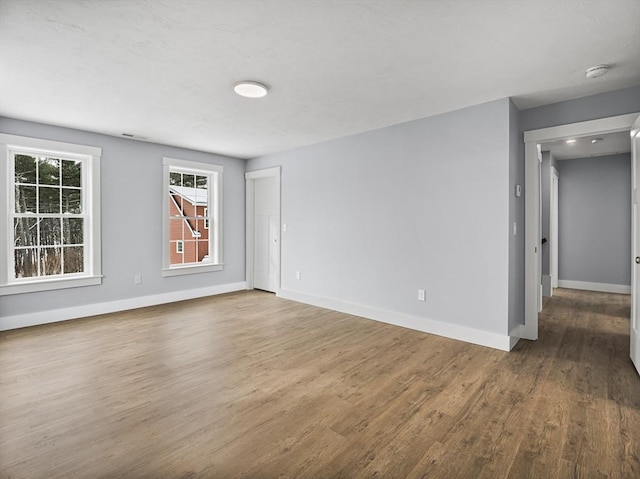 unfurnished room with wood-type flooring