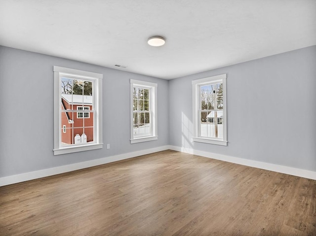 unfurnished room with hardwood / wood-style floors